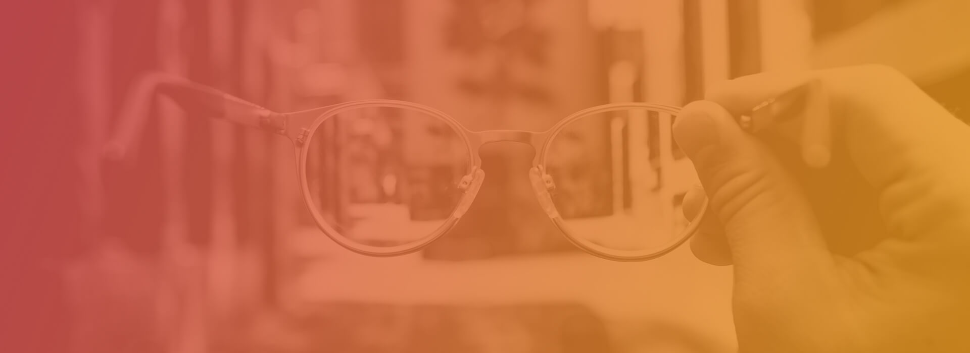 A person holding a pair of glasses that make everything more clear when you look through them