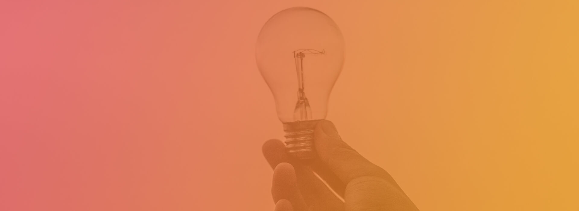 hand holding a lightbulb